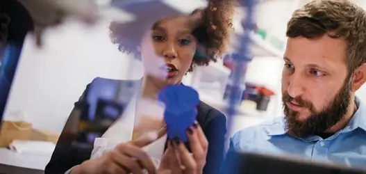Woman and man looking at product in mid conversation